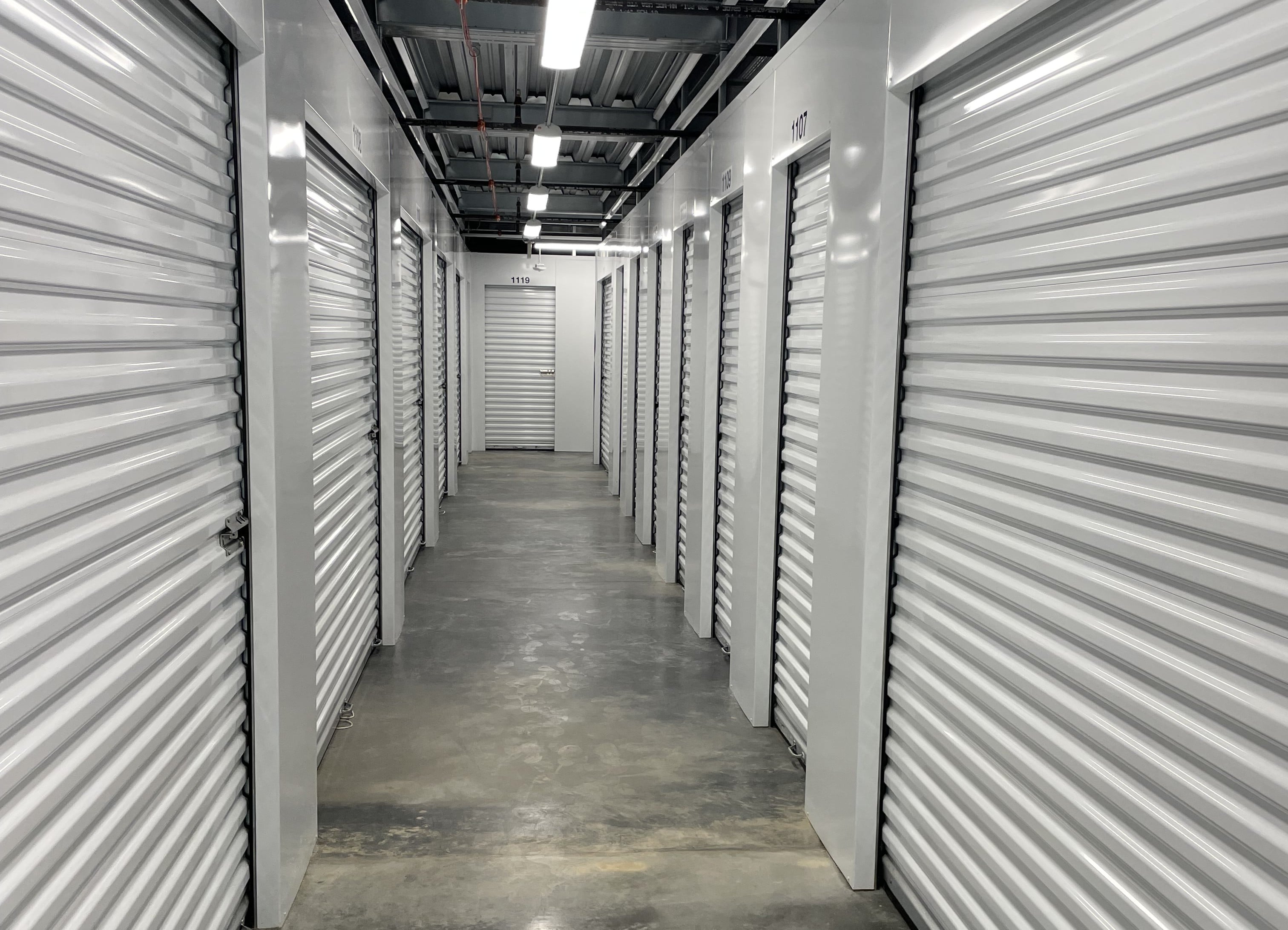 Spotless interior hallway with rolling doors at Stone Spring Storage